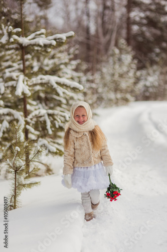 Russian girl in the winter woods with a bouquet of flowers 