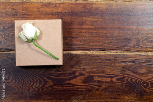 Dried white rose on gift box
