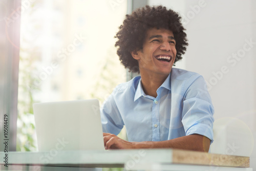 Afro man using laptop 