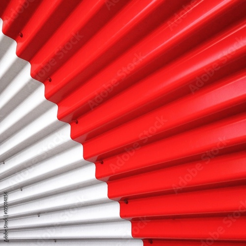 Detail of a metallic sheet in white and red