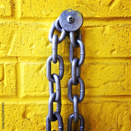Chain on a yellow brick wall