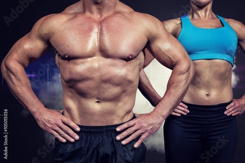 Composite image of midsection of muscular man and woman