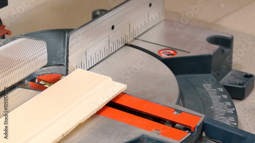 Cutting wooden plank with miter saw