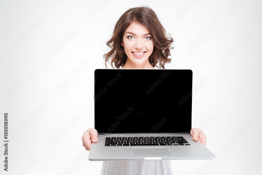 Smiling woman showing blank laptop computer screen Smiling woman showing blank laptop computer screen