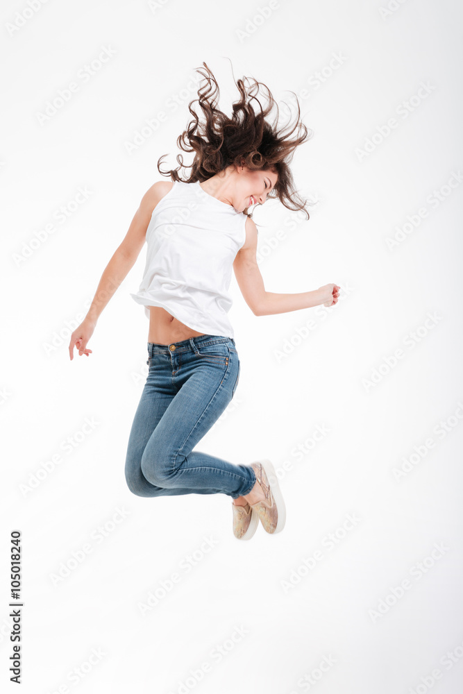 Full length portrait of a happy woman jumping Full length portrait of a happy woman jumping