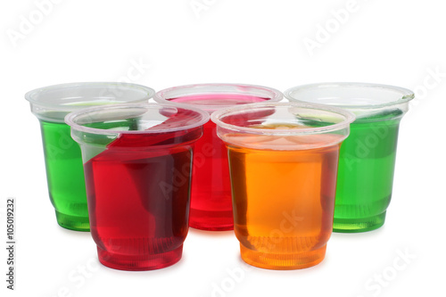 Jam in a glass with raw fruit on white background
