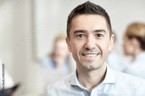 smiling businessman face in office