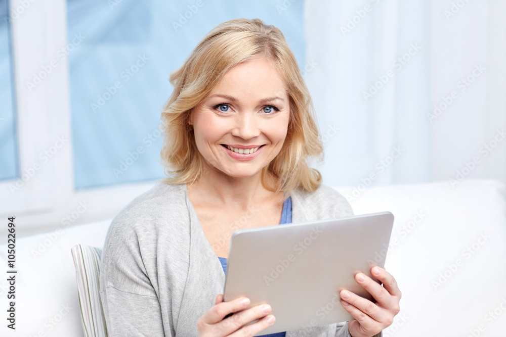 happy middle aged woman with tablet pc at home happy middle aged woman with tablet pc at home