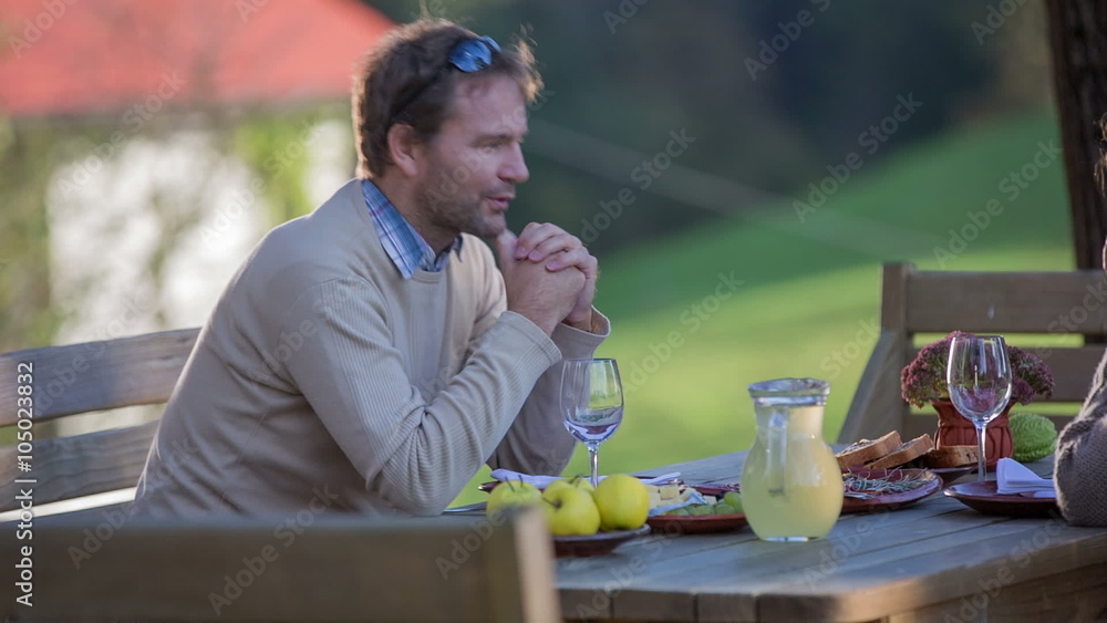 Man talking to the woman across the eating table Man talking to the woman across the eating table