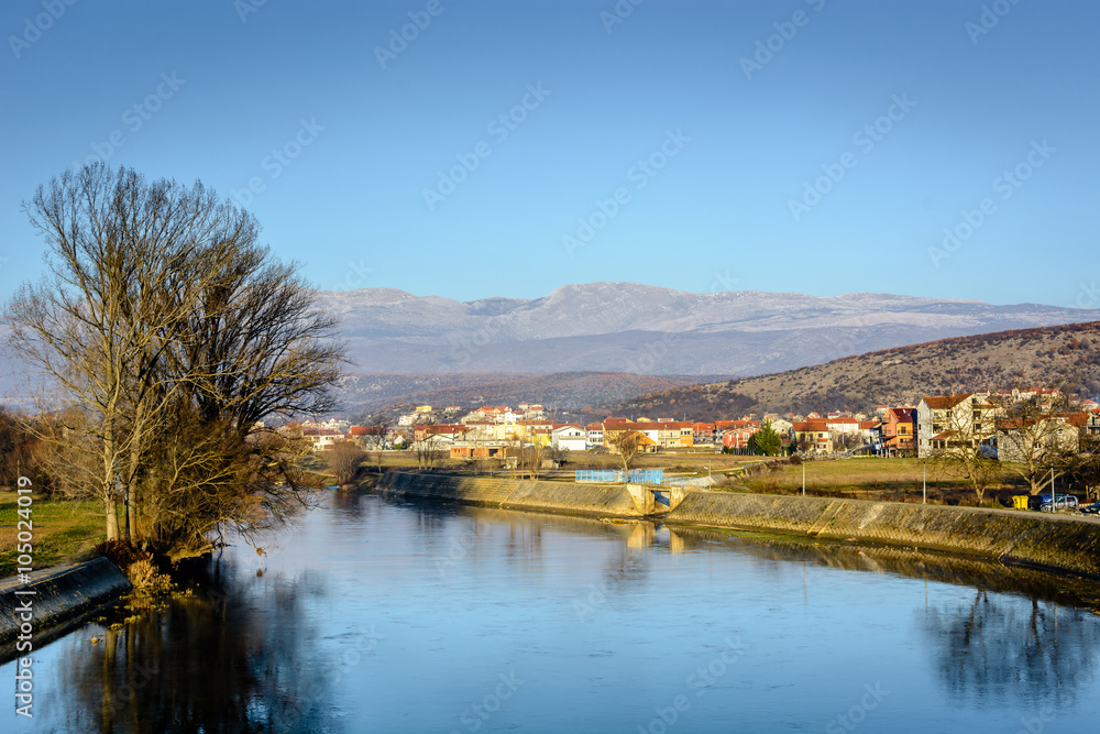 River Cetina and small dalmatian place Trilj, Croatia. / River Cetina is one of main rivers in Dalmatia region. In the background is located small nice town called Trilj.
