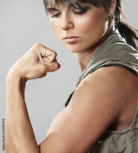 Beautiful young woman clenching fist