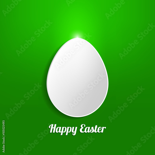 White paper Easter egg on a green background