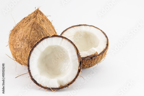 Halved and whole fresh coconuts with leaves