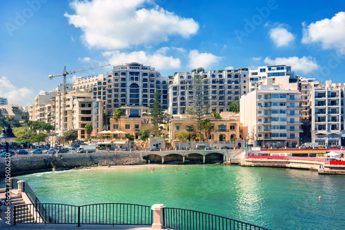 Cityscape with Spinola bay, St. Julians in sunny day, Malta. photo