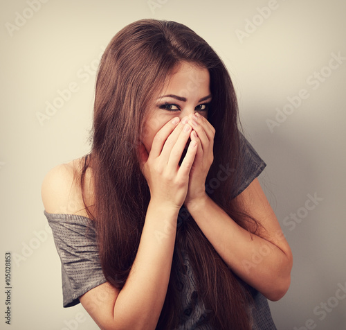 Wallpaper Mural Happy laughing young woman cover two hands her mouth with fun lo Torontodigital.ca