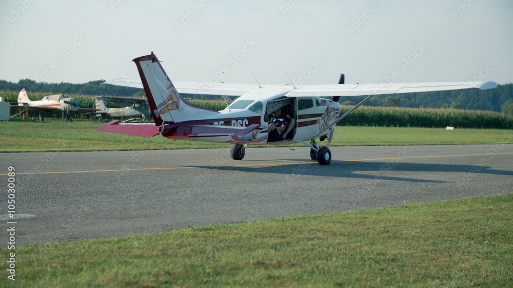 Small plane is taxiing on a runway Small plane is taxiing on a runway