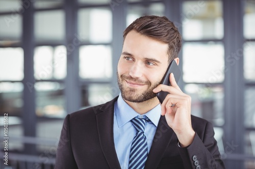 Businessman looking away while talking on mobile phone