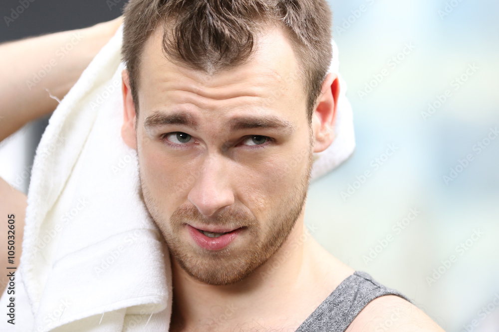 Obraz premium Young handsome man with a towel