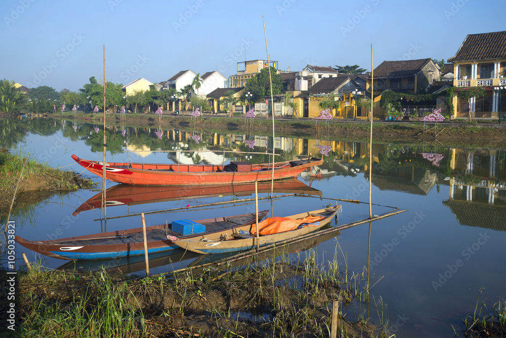 National Vietnamese boats on the background of the waterfront city of Hoi An. Vietnam