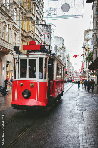 red old tram rides through the streets of Istanbul