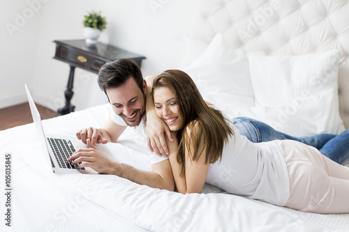 Young couple with laptop in...
