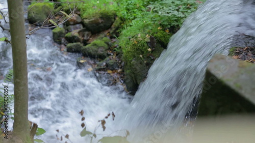 Small waterfall under the bridge photo