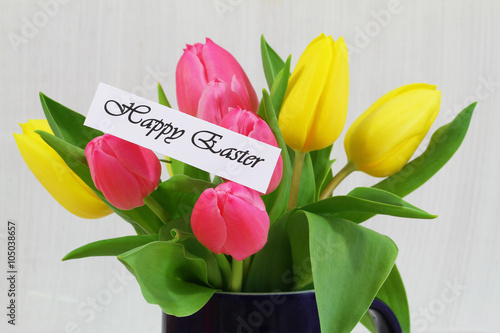 Happy Easater card with red and yellow tulips in navy blue mug
