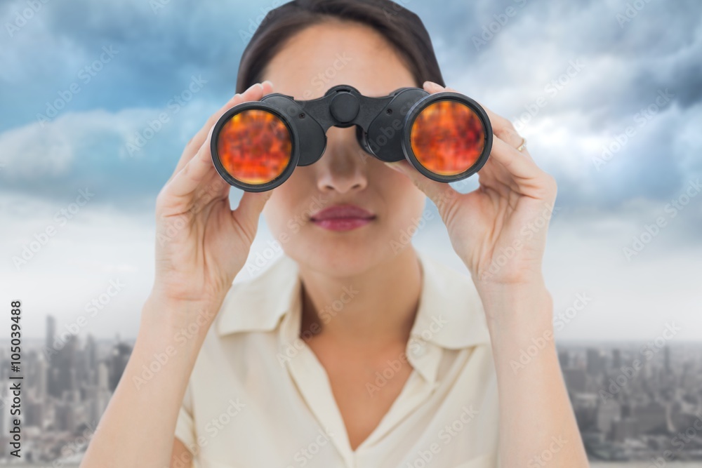Composite image of a businesswoman looking through binocular Composite image of a businesswoman looking through binocular