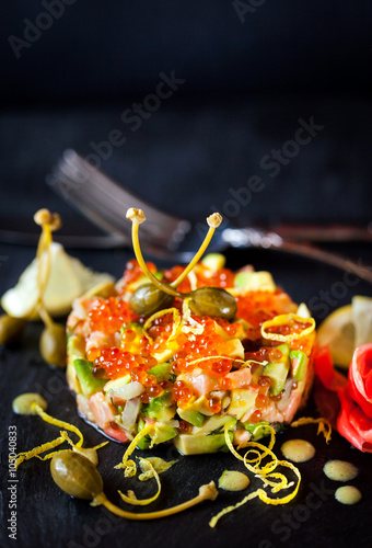 Foto Red caviar, salmon and avocado tartar