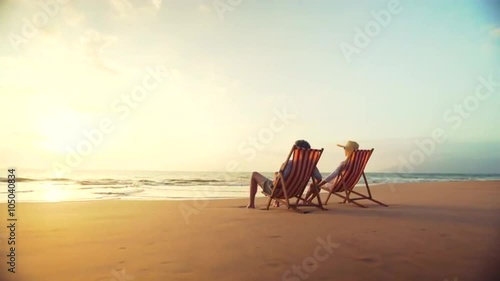 4K Retirement Vacation Concept, Happy Mature Retired Couple Enjoying Beautiful Sunset at the Beach