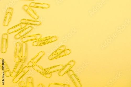 yellow paper clips on a yellow sheet of paper