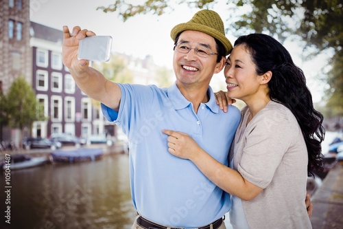 Composite image of man and woman taking a picture photo