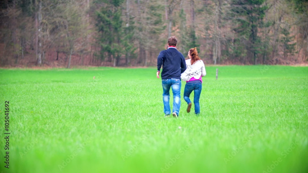 Couple running on a meadow Couple running on a meadow