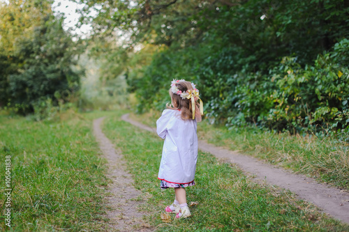 Little girl walks on a path