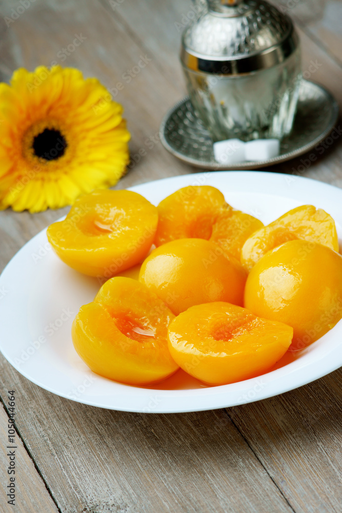 Peaches on the dish, gerber and sugar-bowl