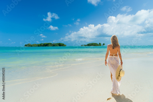 Woman with sarong walking on the beach