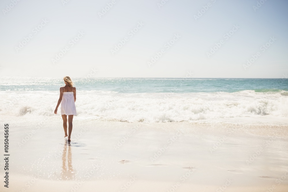 Blonde woman close to water at the beach