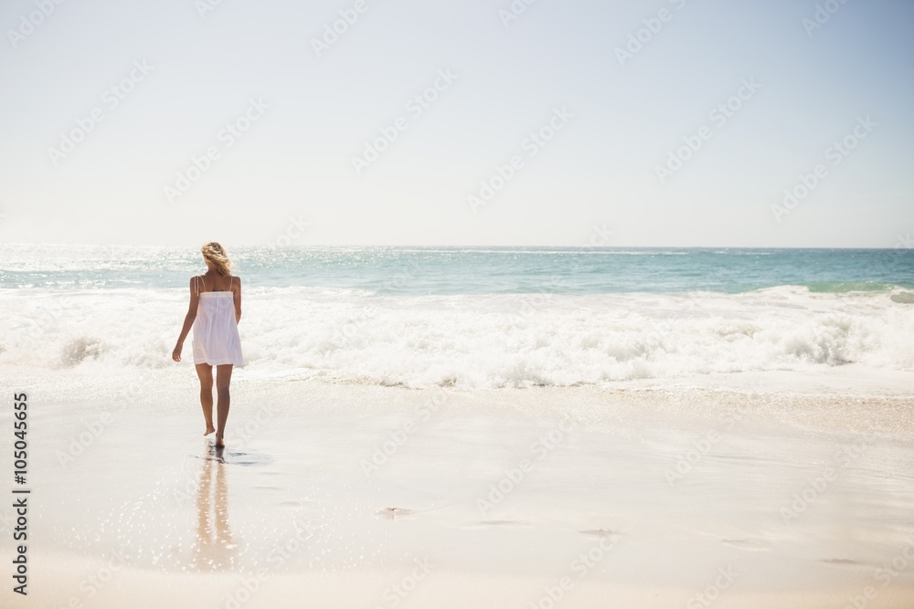 Blonde woman close to water at the beach Blonde woman close to water at the beach