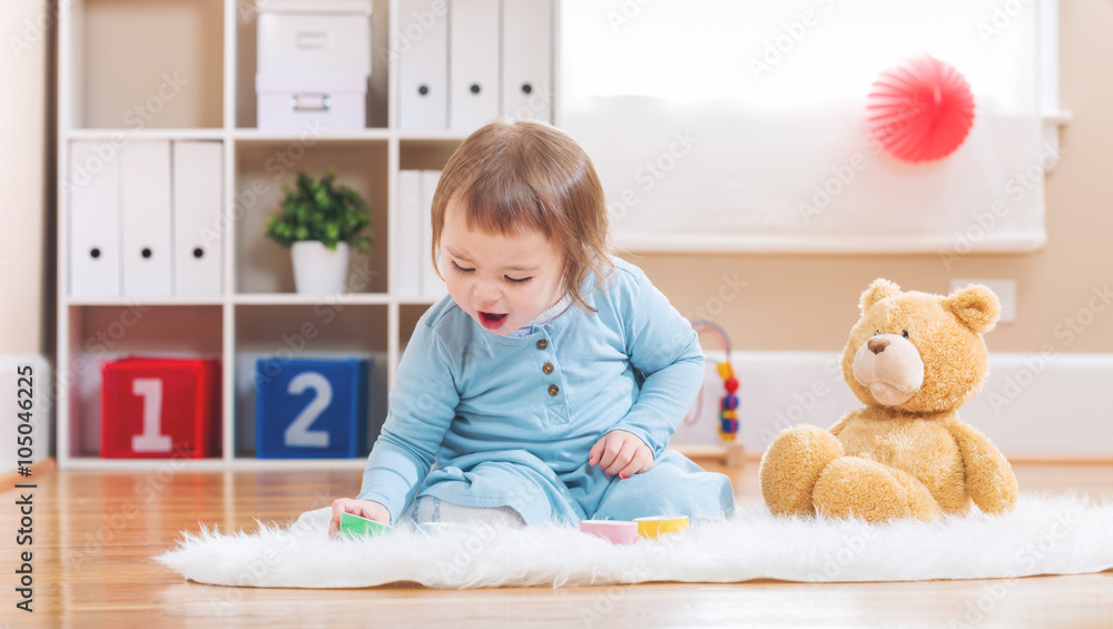 Toddler girl have tea with her teddy bear Toddler girl have tea with her teddy bear