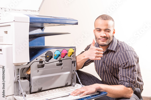 african technician fix office photo copier