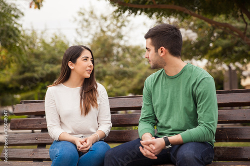 Young couple talking at a park