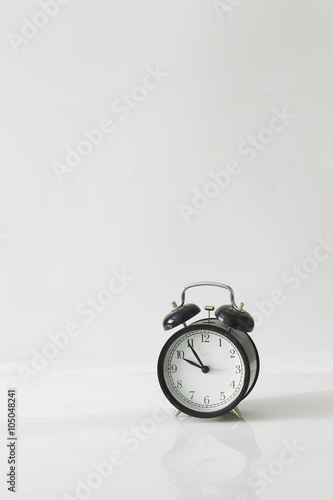 Alarm clock on white background, minimalism