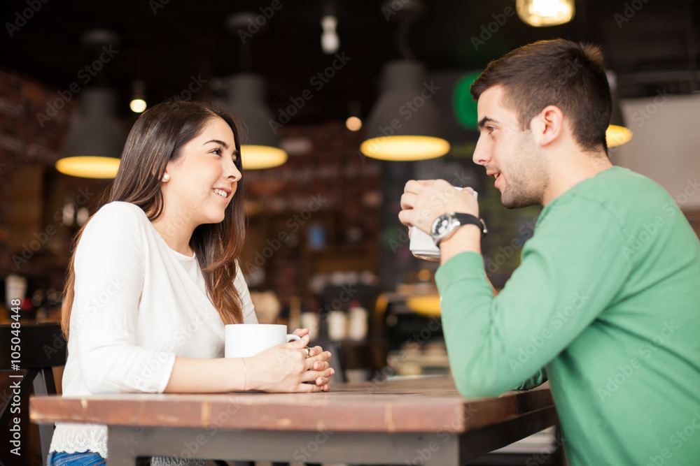 Cute couple drinking coffee at a restaurant
