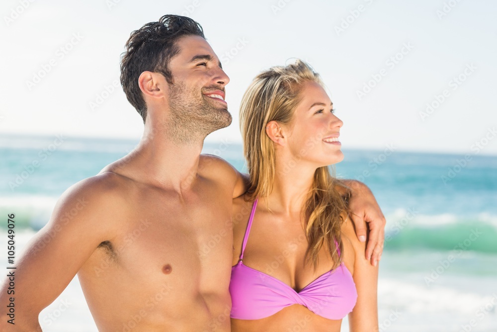 Happy couple hugging on the beach Happy couple hugging on the beach