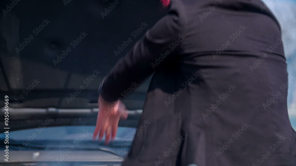 Angry woman hitting a guy because he can not fix the car Angry woman hitting a guy because he can not fix the car