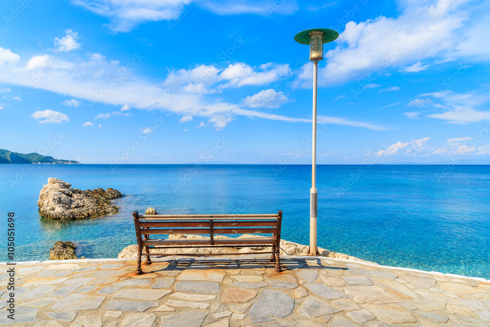 Bench on coastal promenade along Kokkari beach, Samos island, Greece