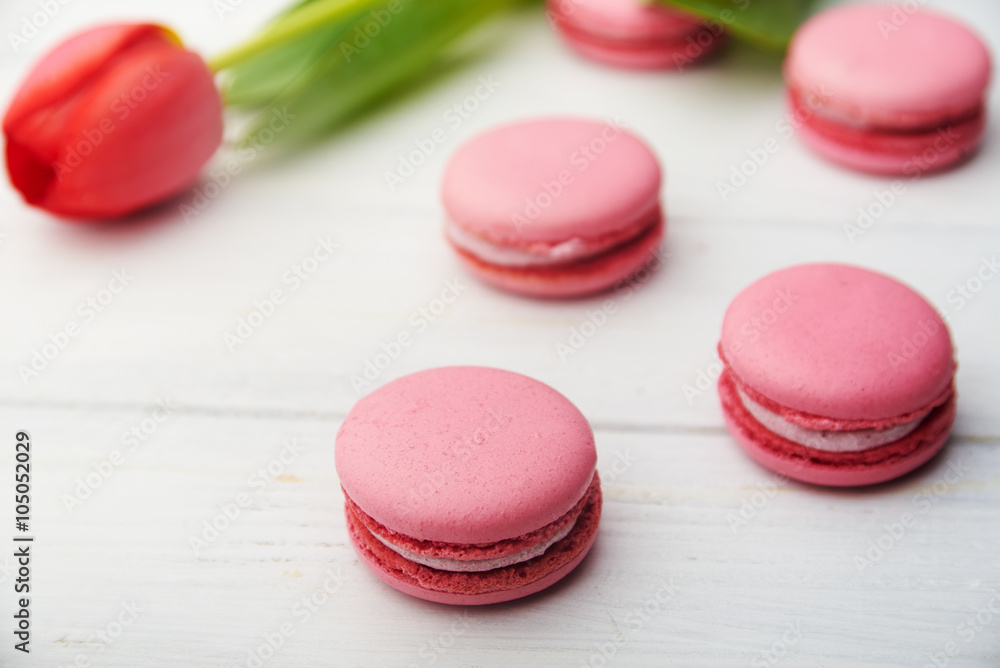 Sweet pink macaroons on wooden table Sweet pink macaroons on wooden table