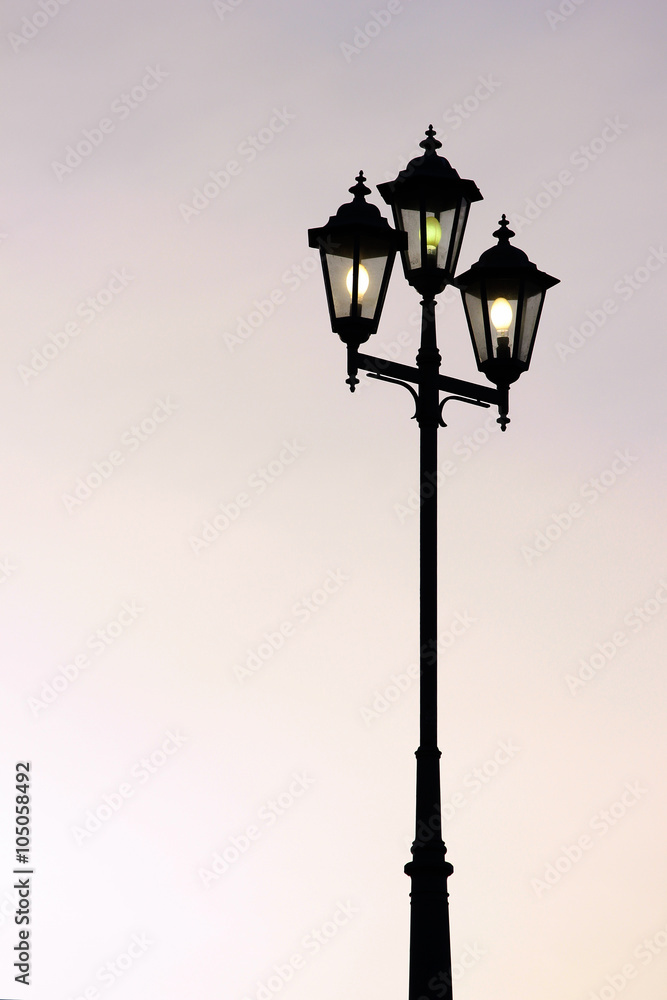 Old street lamppost against twilight background