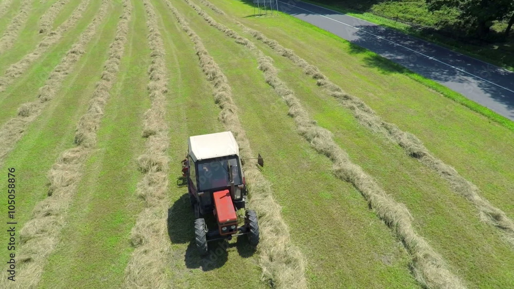 Retro tractor is hay harvesting Retro tractor is hay harvesting