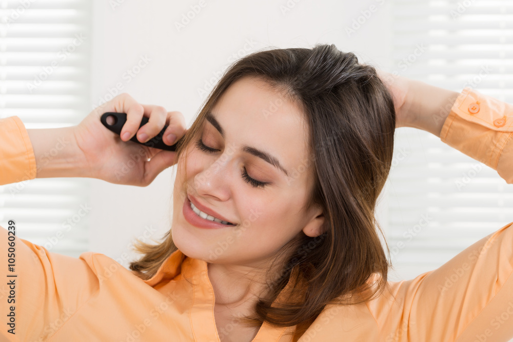 Fototapeta premium Woman Brushing Her Hair